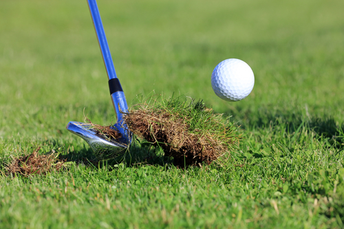 chipping-golf-ball-out-of-the-rough-grass-with-divot
