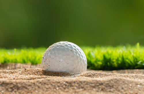 Golf ball in sand bunker