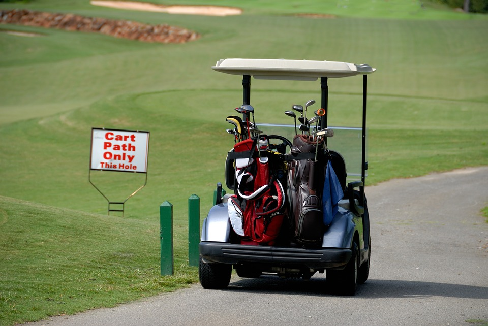 Golf cart carrying bags with clubs