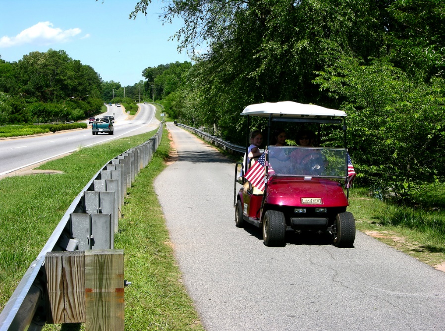 Golf cart driving on trail