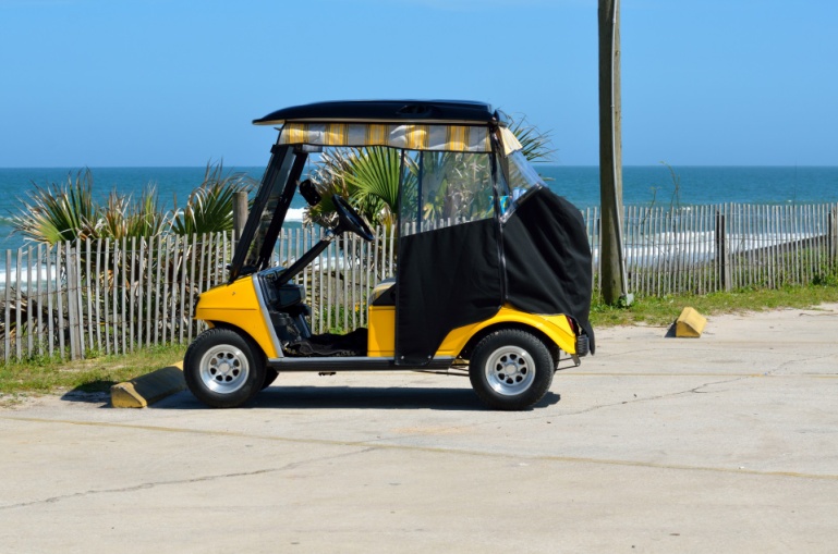 Golf cart parked on beach
