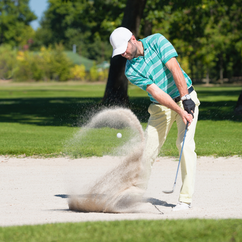 Golfer-hits-the-ball-out-of-sand-trap