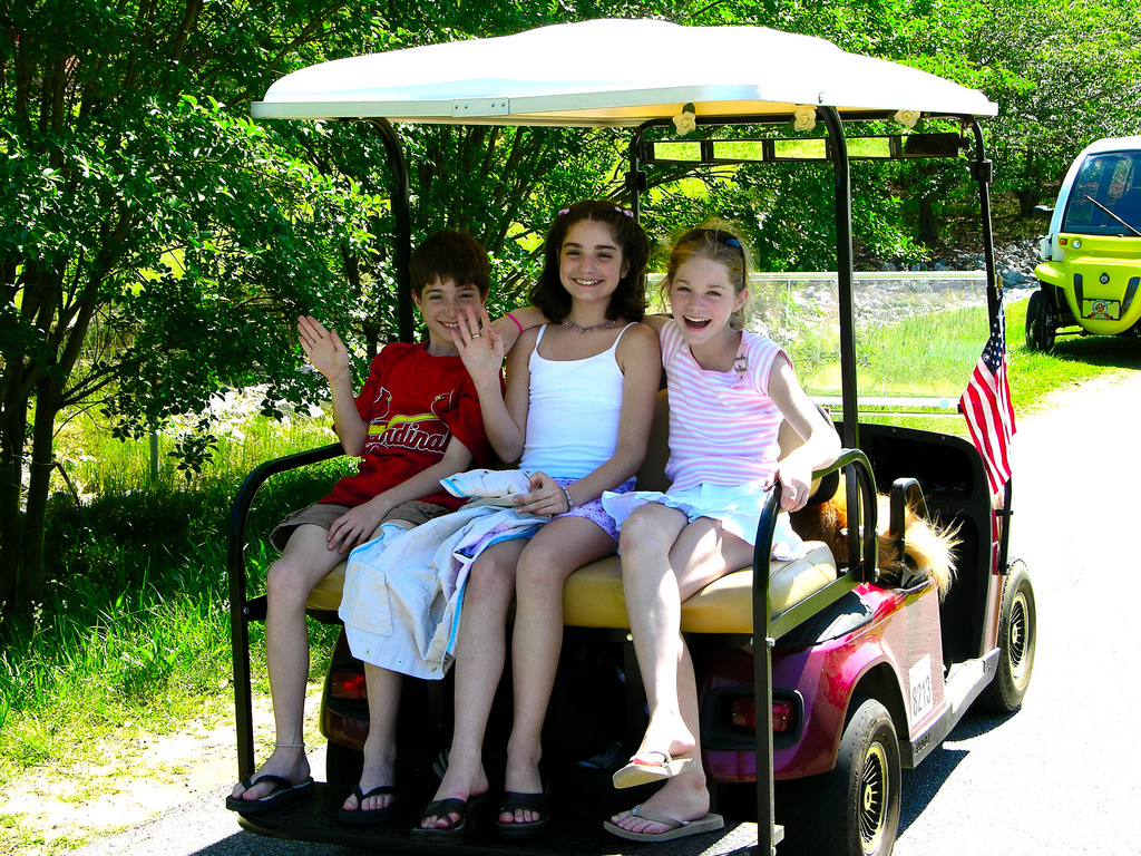 Kids-on-rear-seat-of-golf-cart