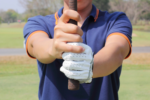 man preparing grip golf club