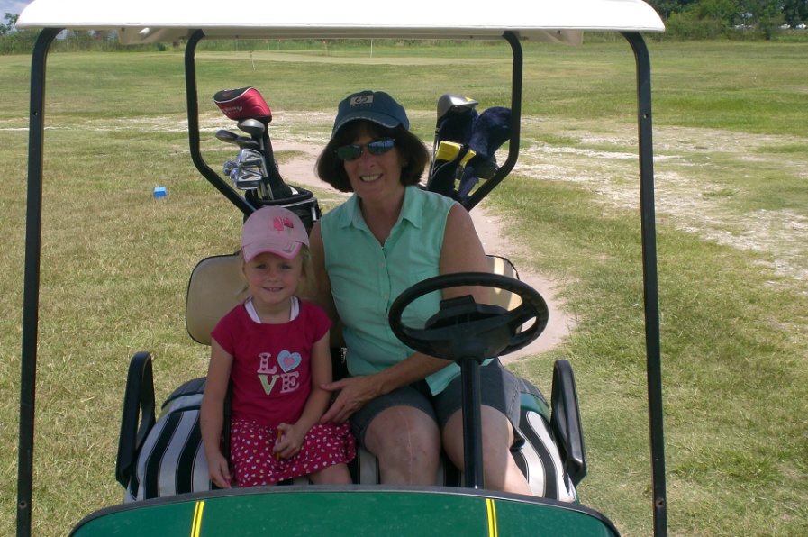 Mom and daughter in golf cart