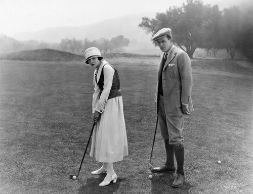 profile-of-a-couple-playing-golf-in-a-golf-course