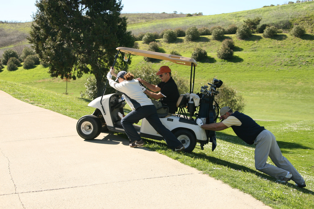 Pushing-golf-cart-up-hill