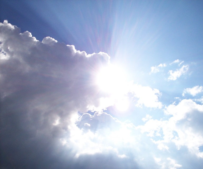 Sun shining through dark clouds